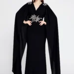 Amber Black – Elegant Cape-Sleeve Gown with Embellished Waist